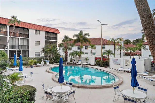 a view of a swimming pool with chairs