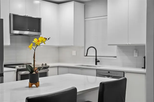 a kitchen with a sink and a microwave