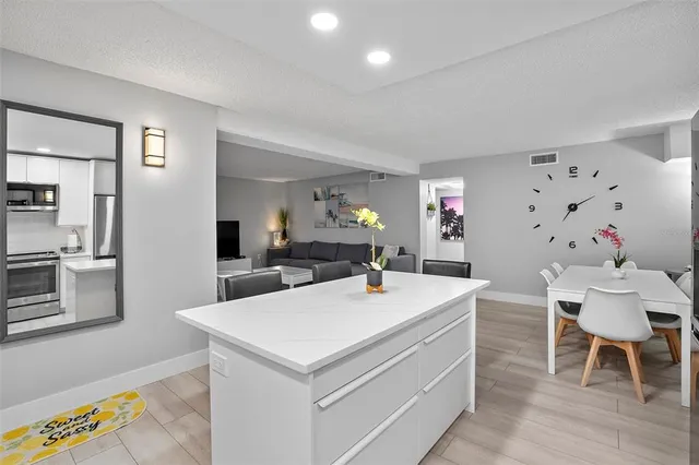 a view of kitchen island with furniture and wooden floor