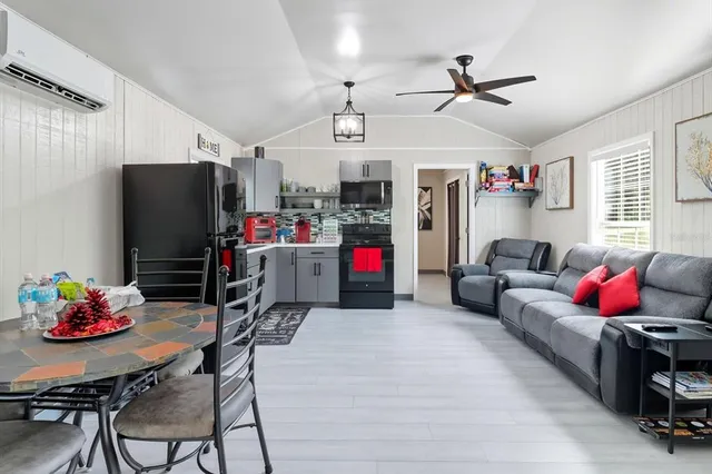 a living room with furniture kitchen and a window