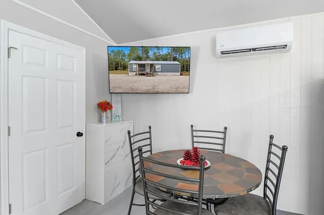 a dining room with furniture and wooden floor