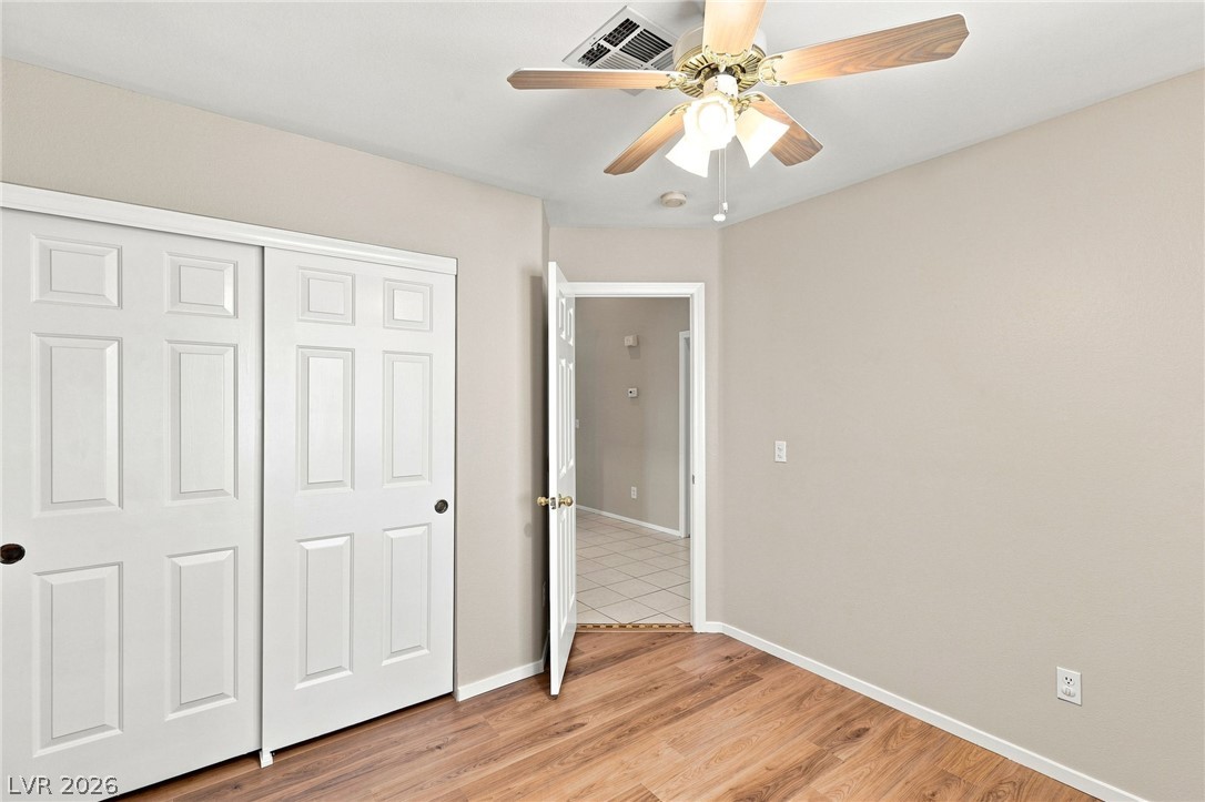 904 Shadowfax Road Henderson, NV 89015 - Photo 20 of 31 Gleaming wood-look floors complement the clean lines of this quiet bedroom space.