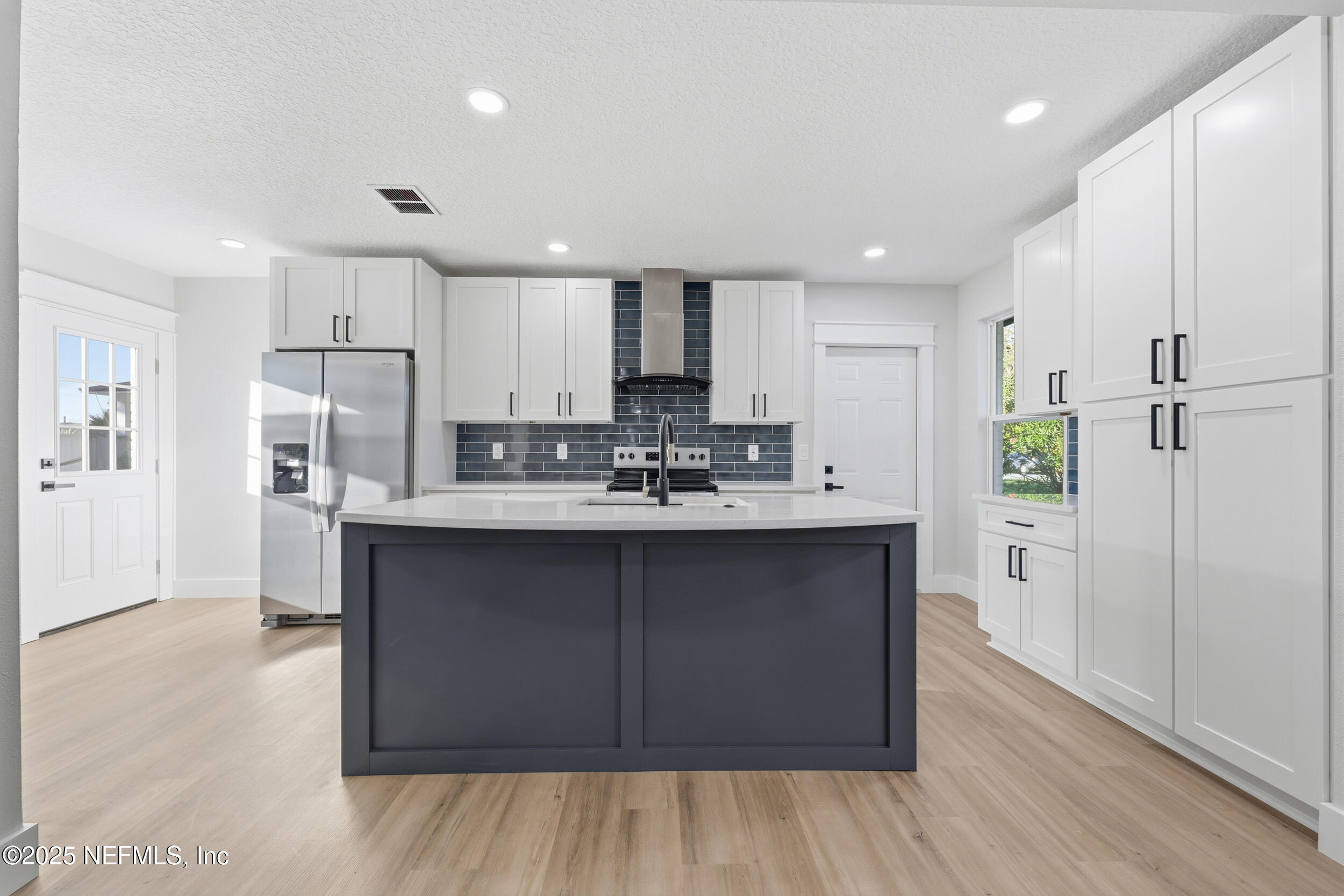 1440 Harbor Oaks Road Jacksonville, FL 32207 - Photo 14 of 63 a kitchen with kitchen island a sink stainless steel appliances and cabinets