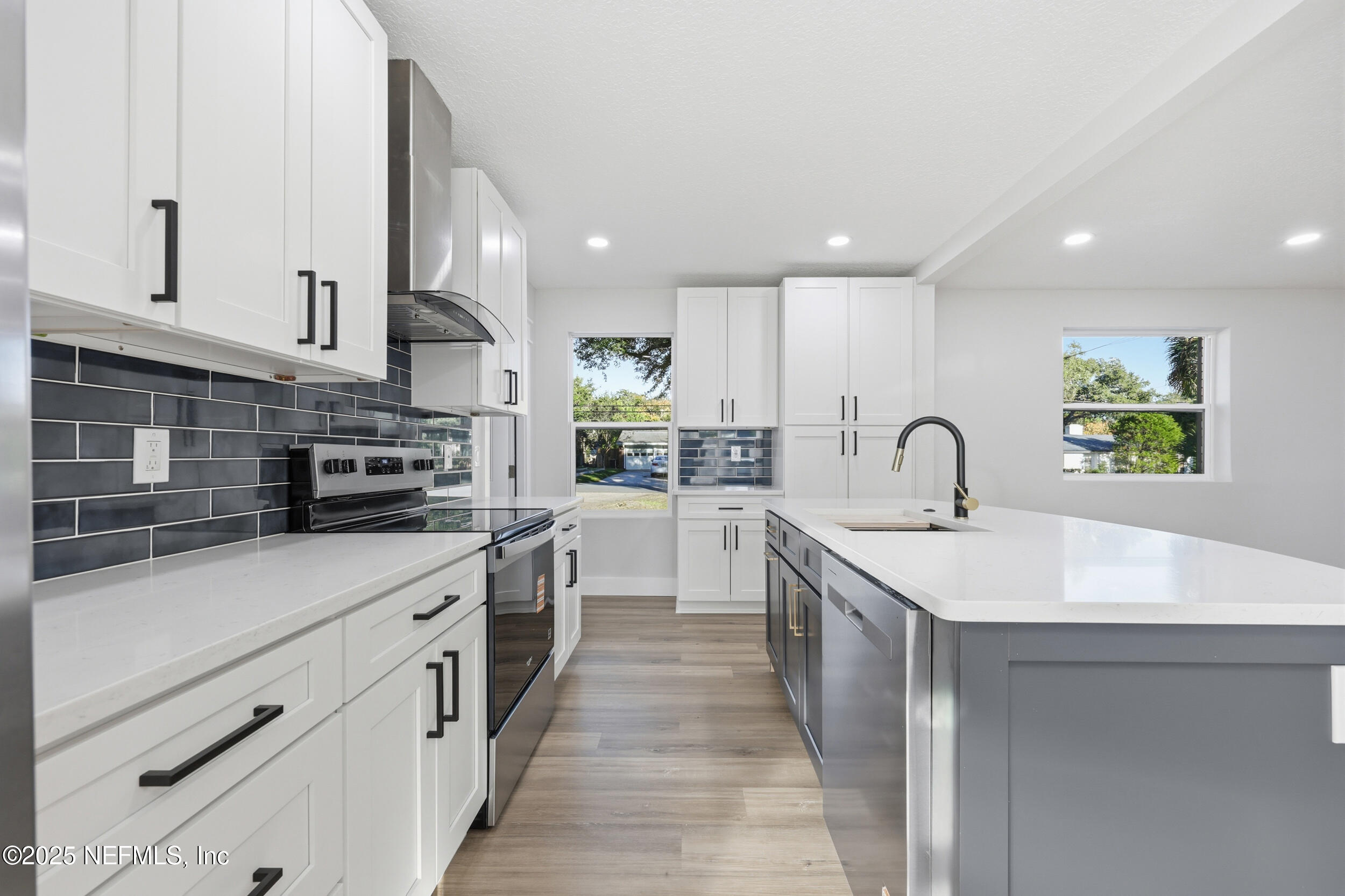 1440 Harbor Oaks Road Jacksonville, FL 32207 - Photo 16 of 63 a kitchen with stainless steel appliances a sink stove and cabinets