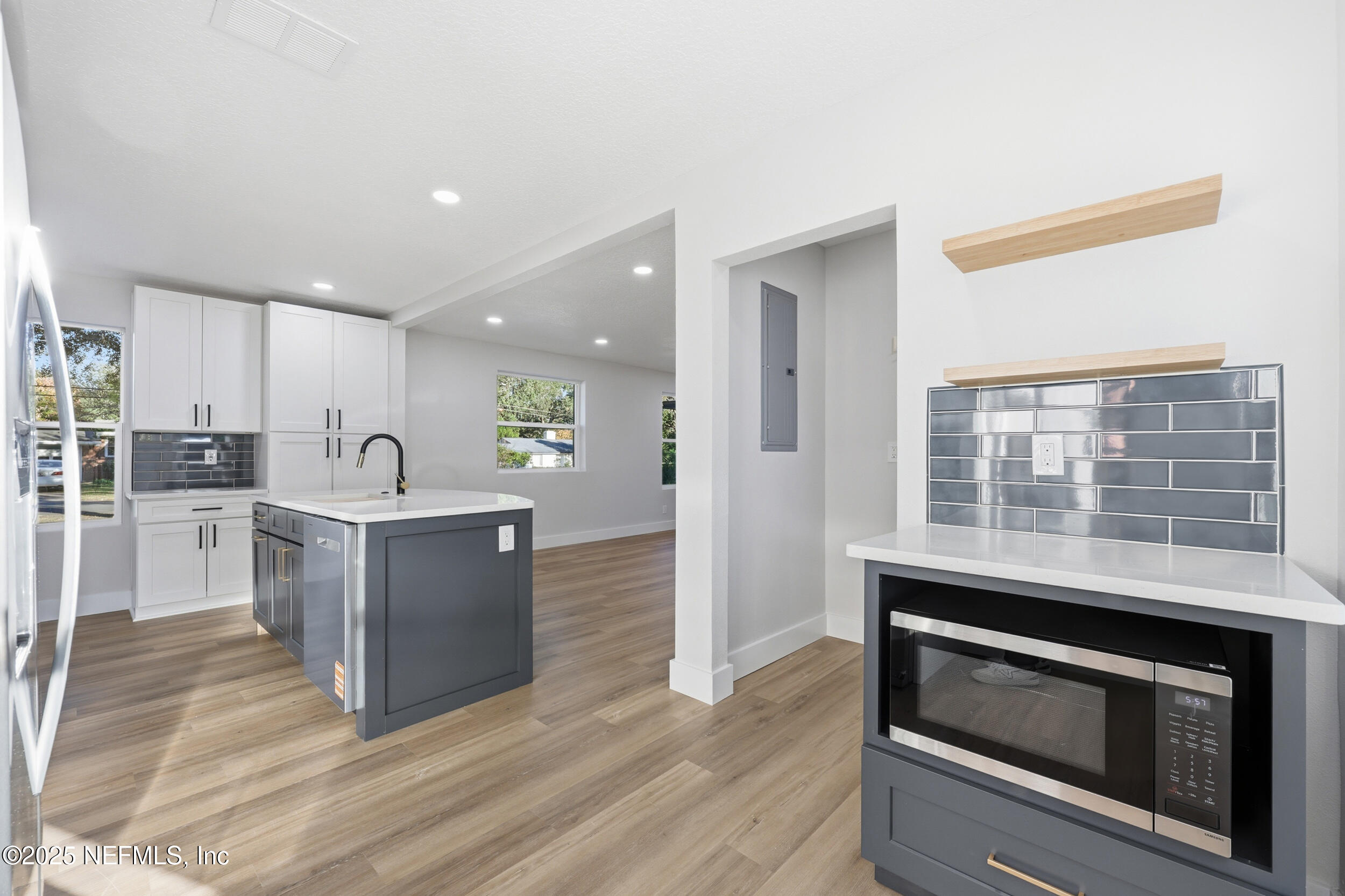 1440 Harbor Oaks Road Jacksonville, FL 32207 - Photo 22 of 63 a kitchen with granite countertop a stove top oven and cabinets