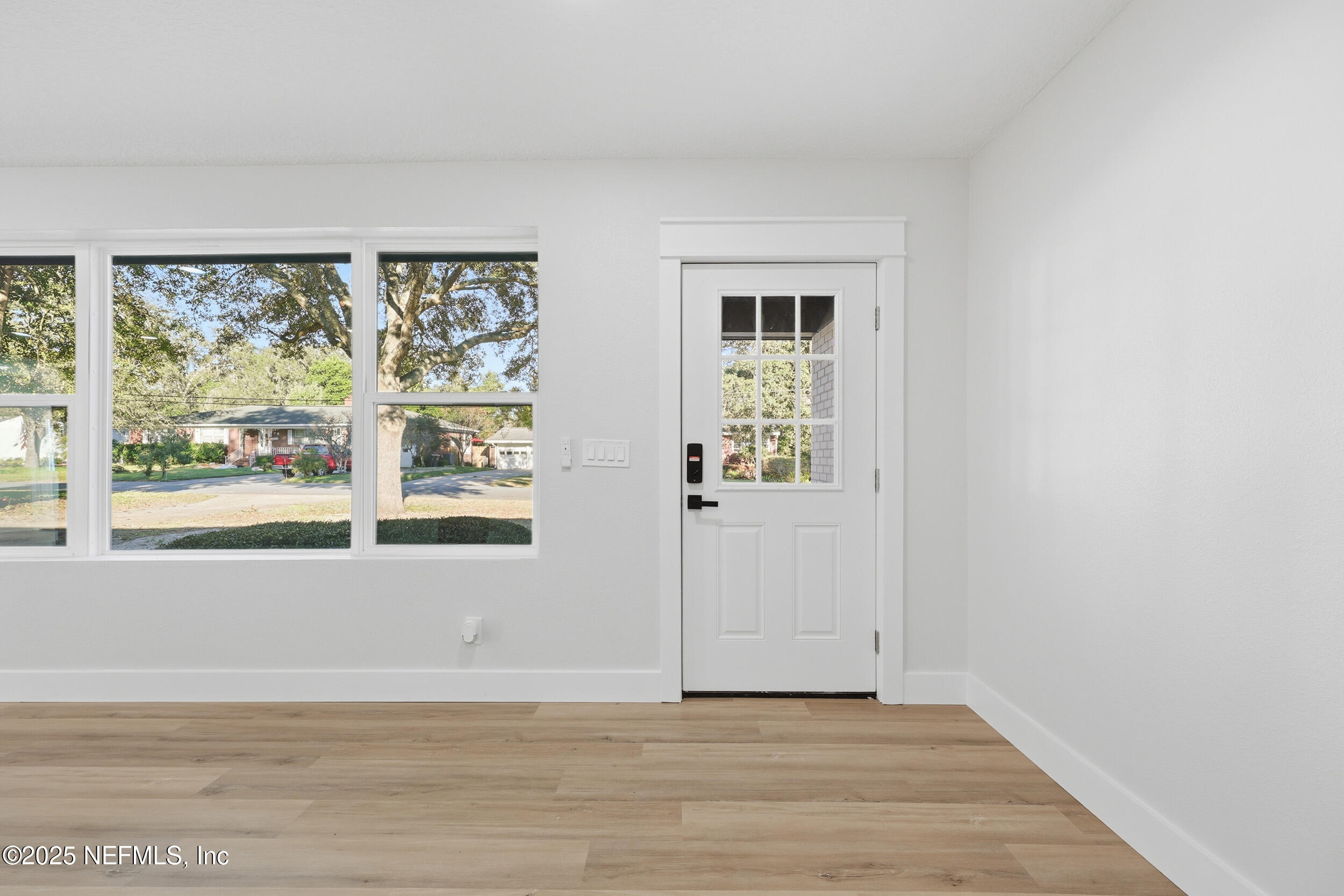 1440 Harbor Oaks Road Jacksonville, FL 32207 - Photo 3 of 63 a view of an empty room with wooden floor and a window