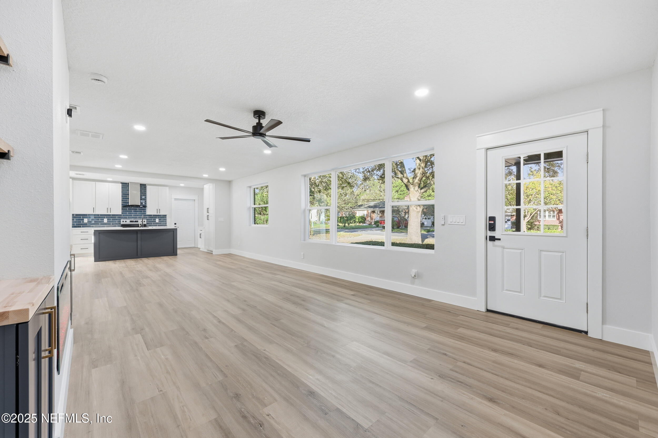 1440 Harbor Oaks Road Jacksonville, FL 32207 - Photo 9 of 63 a view of an empty room with a window and wooden floor