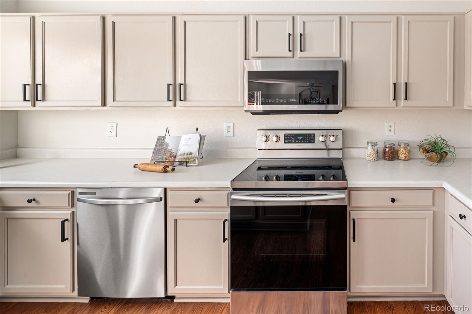 9741 Moss Rose Circle Highlands Ranch, CO 80129 - Photo 13 of 46 a kitchen with white cabinets and appliances