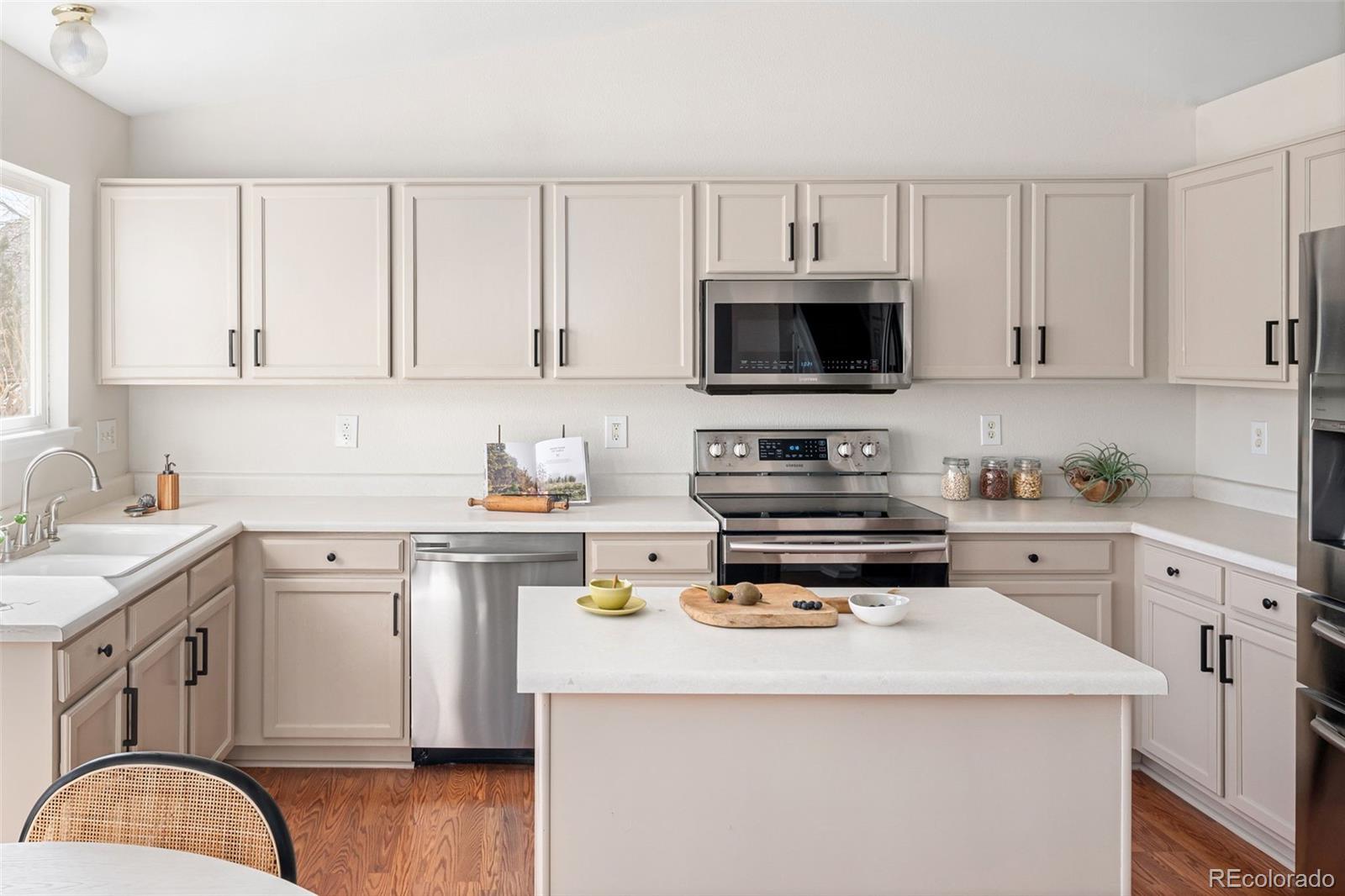 9741 Moss Rose Circle Highlands Ranch, CO 80129 - Photo 14 of 46 a kitchen with appliances a sink and cabinets