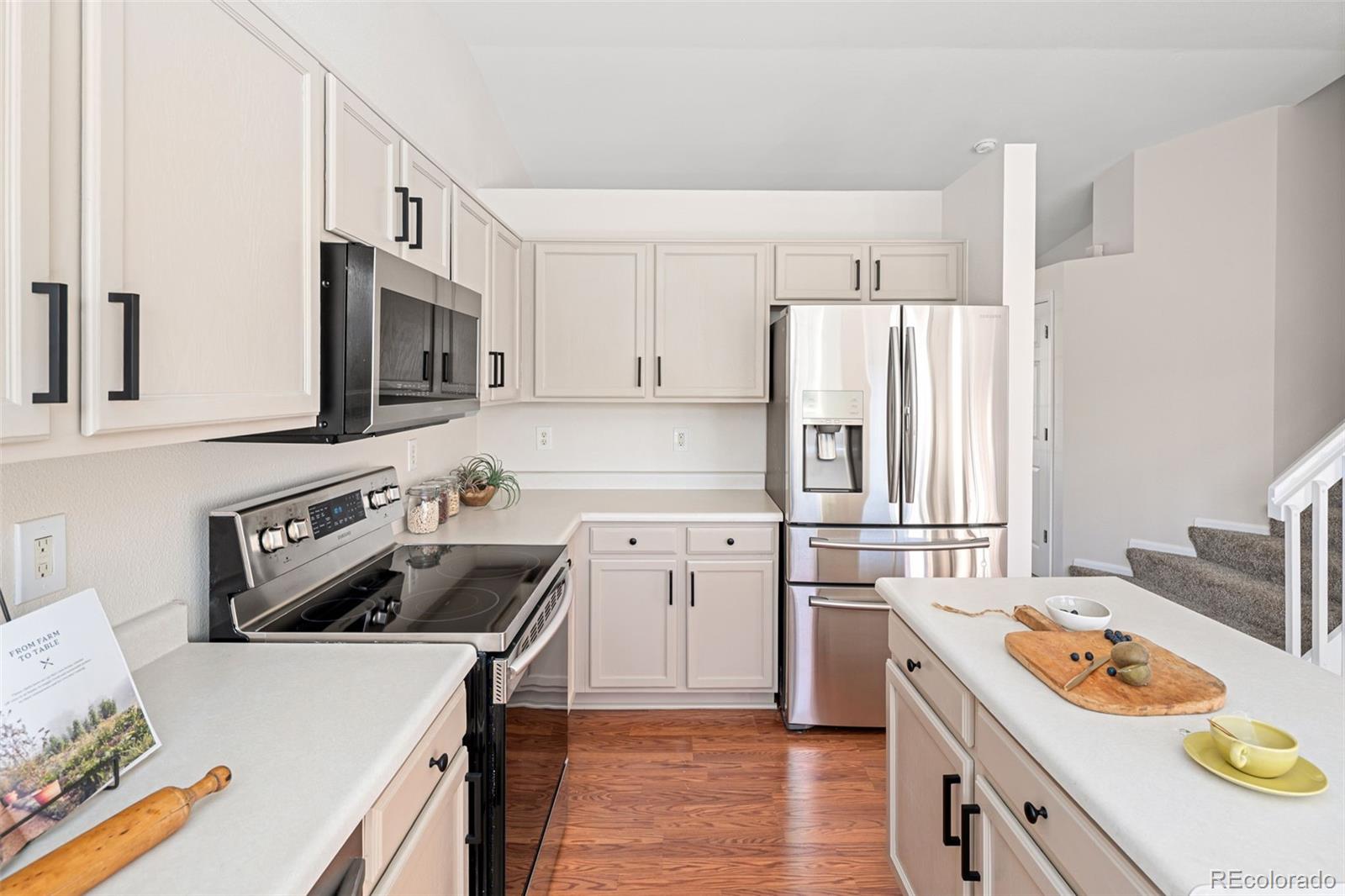 9741 Moss Rose Circle Highlands Ranch, CO 80129 - Photo 15 of 46 a kitchen with a stove a sink and a refrigerator