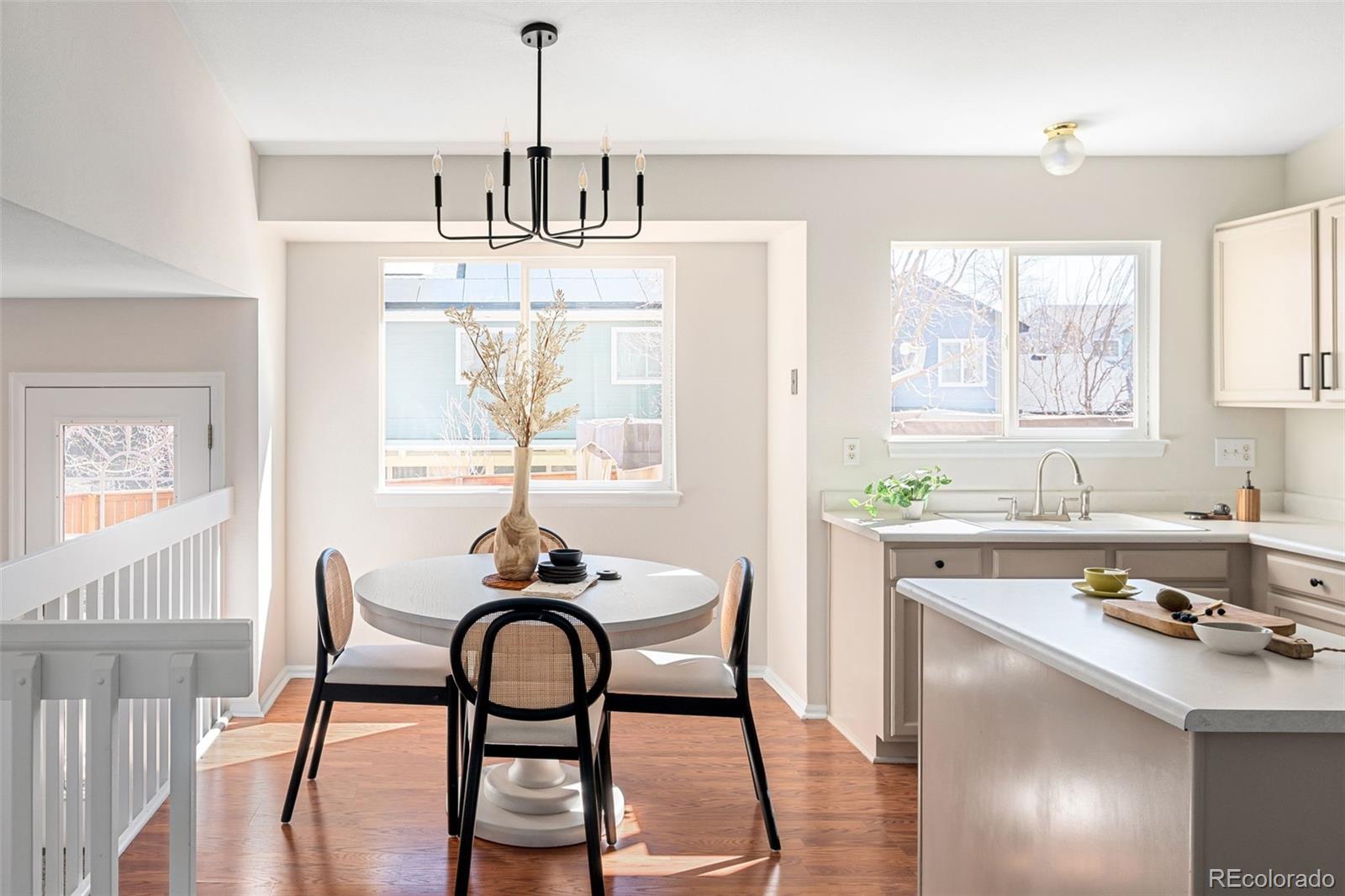 9741 Moss Rose Circle Highlands Ranch, CO 80129 - Photo 17 of 46 a kitchen with a dining table chairs and granite counter tops