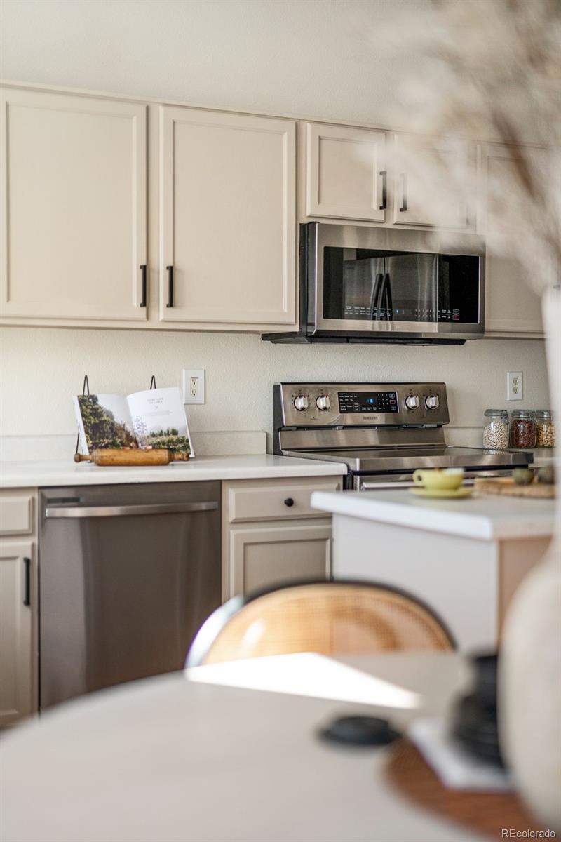 9741 Moss Rose Circle Highlands Ranch, CO 80129 - Photo 19 of 46 a kitchen with stainless steel appliances granite countertop a sink and a stove