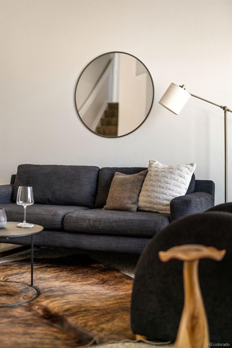 9741 Moss Rose Circle Highlands Ranch, CO 80129 - Photo 22 of 46 a living room with furniture and a lamp