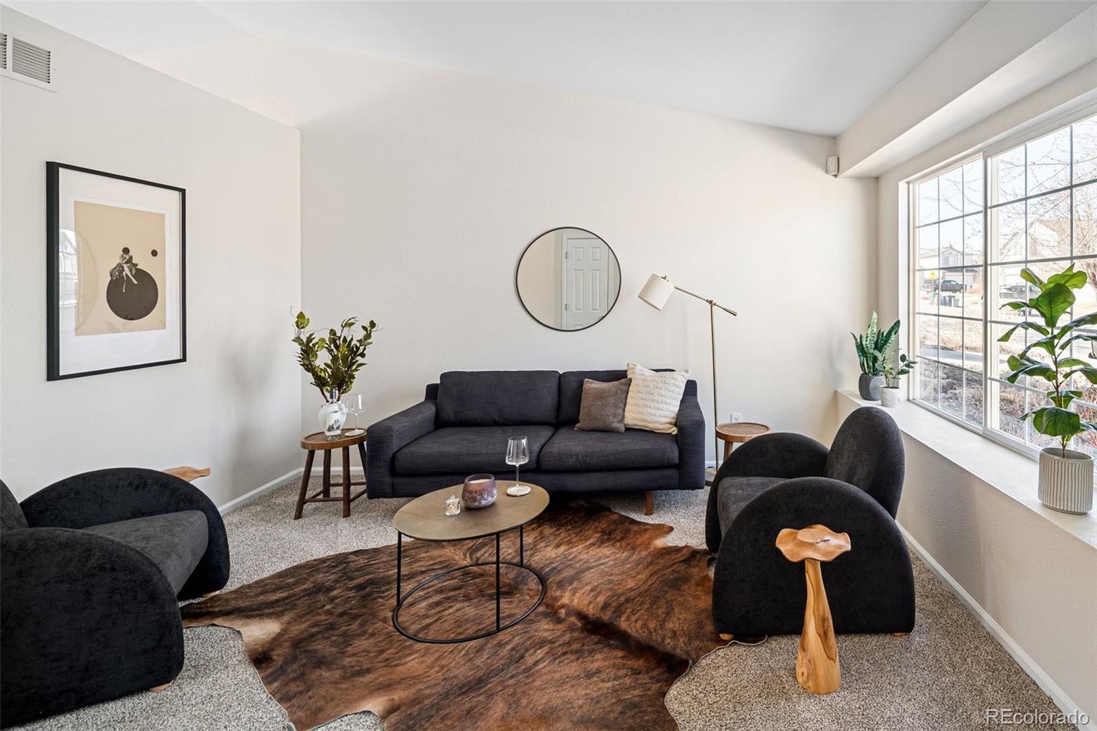 9741 Moss Rose Circle Highlands Ranch, CO 80129 - Photo 24 of 46 a living room with furniture lamp and window
