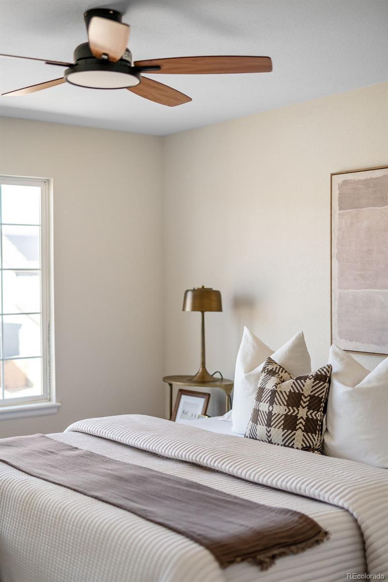 9741 Moss Rose Circle Highlands Ranch, CO 80129 - Photo 27 of 46 a bedroom with a bed and a mirror