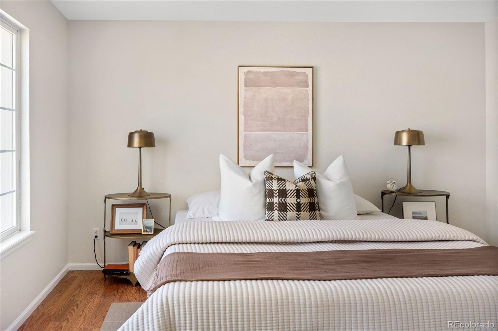 9741 Moss Rose Circle Highlands Ranch, CO 80129 - Photo 28 of 46 a bedroom with a bed and wooden floor