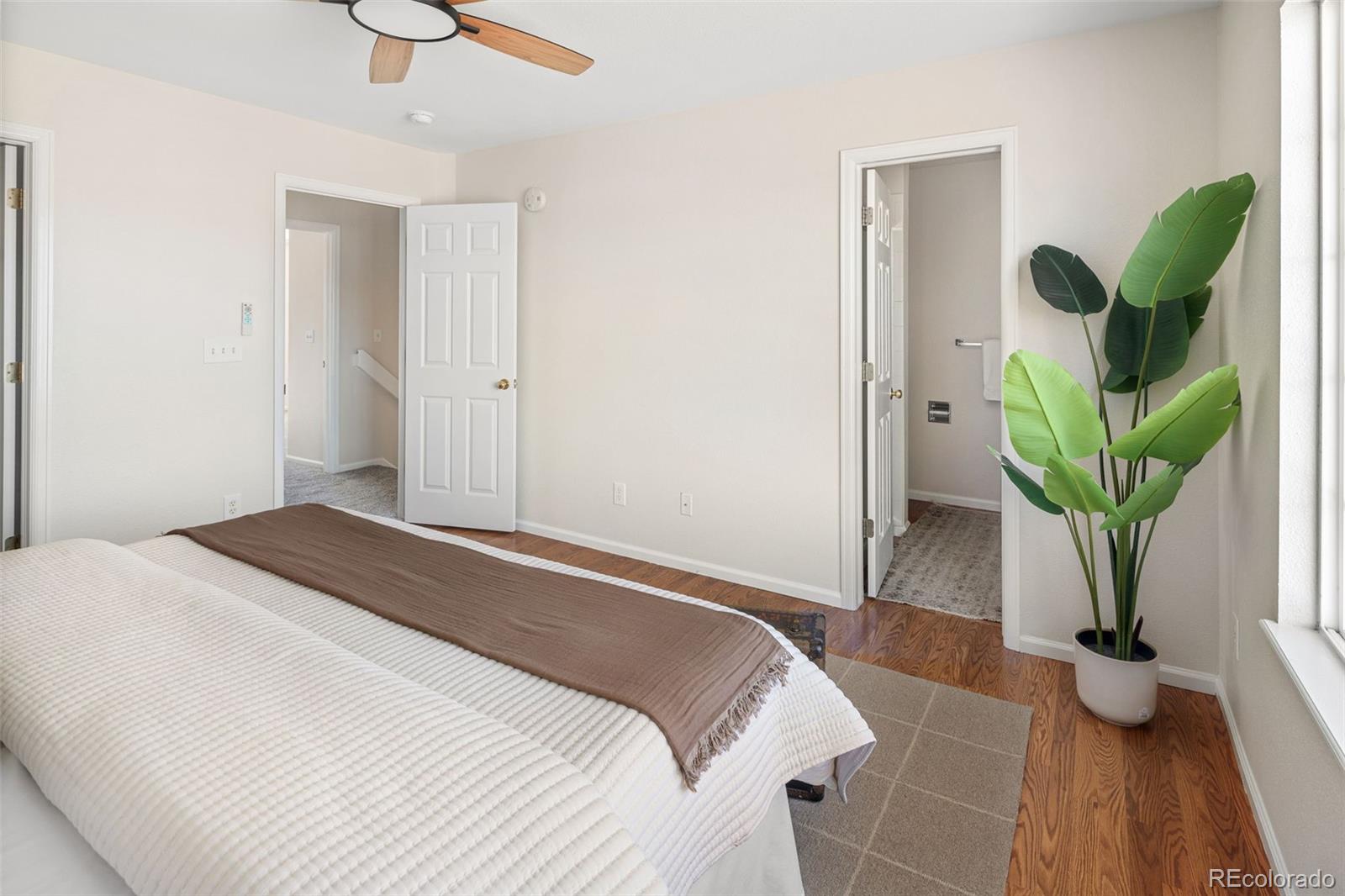 9741 Moss Rose Circle Highlands Ranch, CO 80129 - Photo 29 of 46 a bedroom with bed and a potted plant