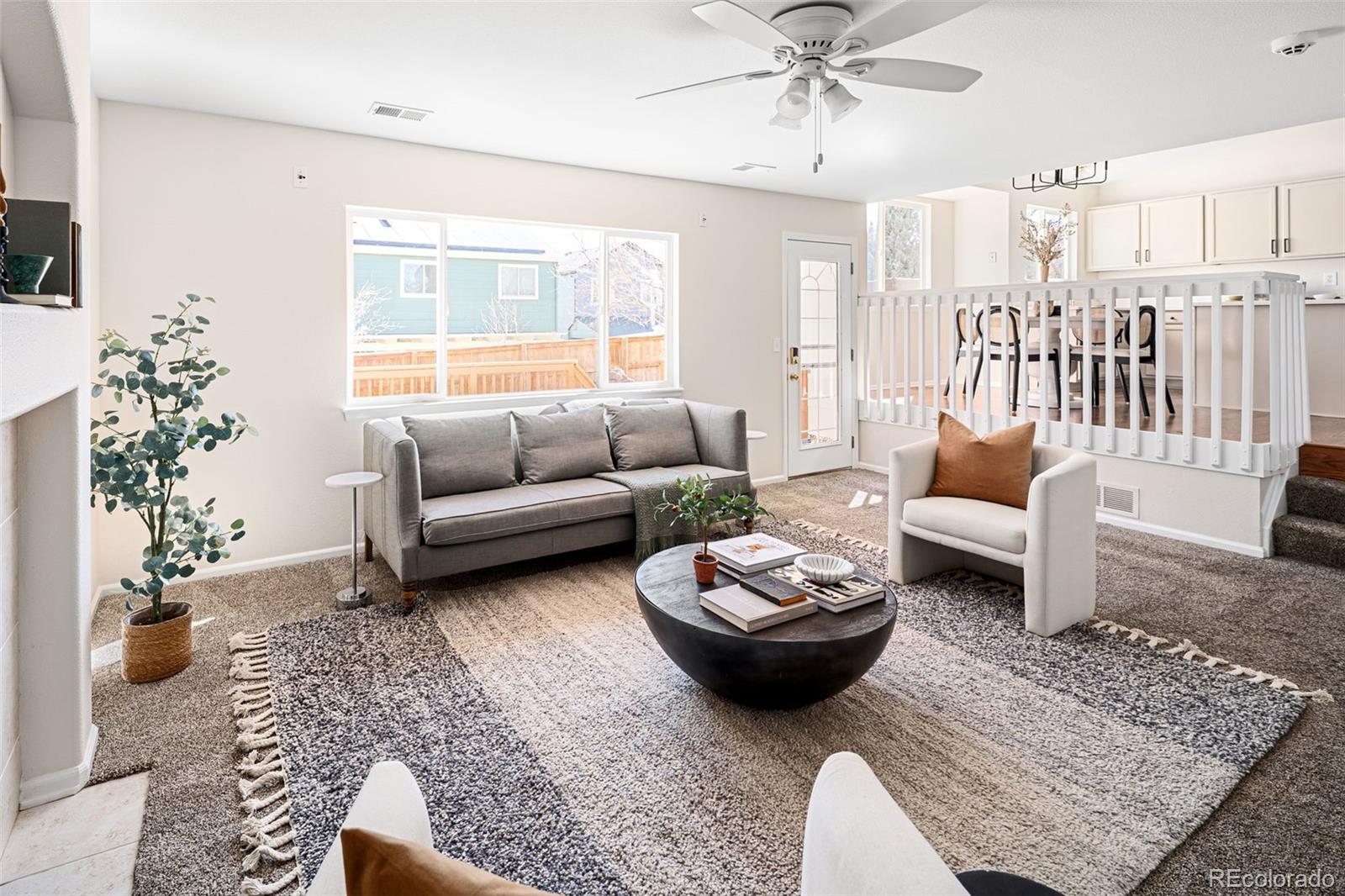 9741 Moss Rose Circle Highlands Ranch, CO 80129 - Photo 3 of 46 a living room with furniture and a large window