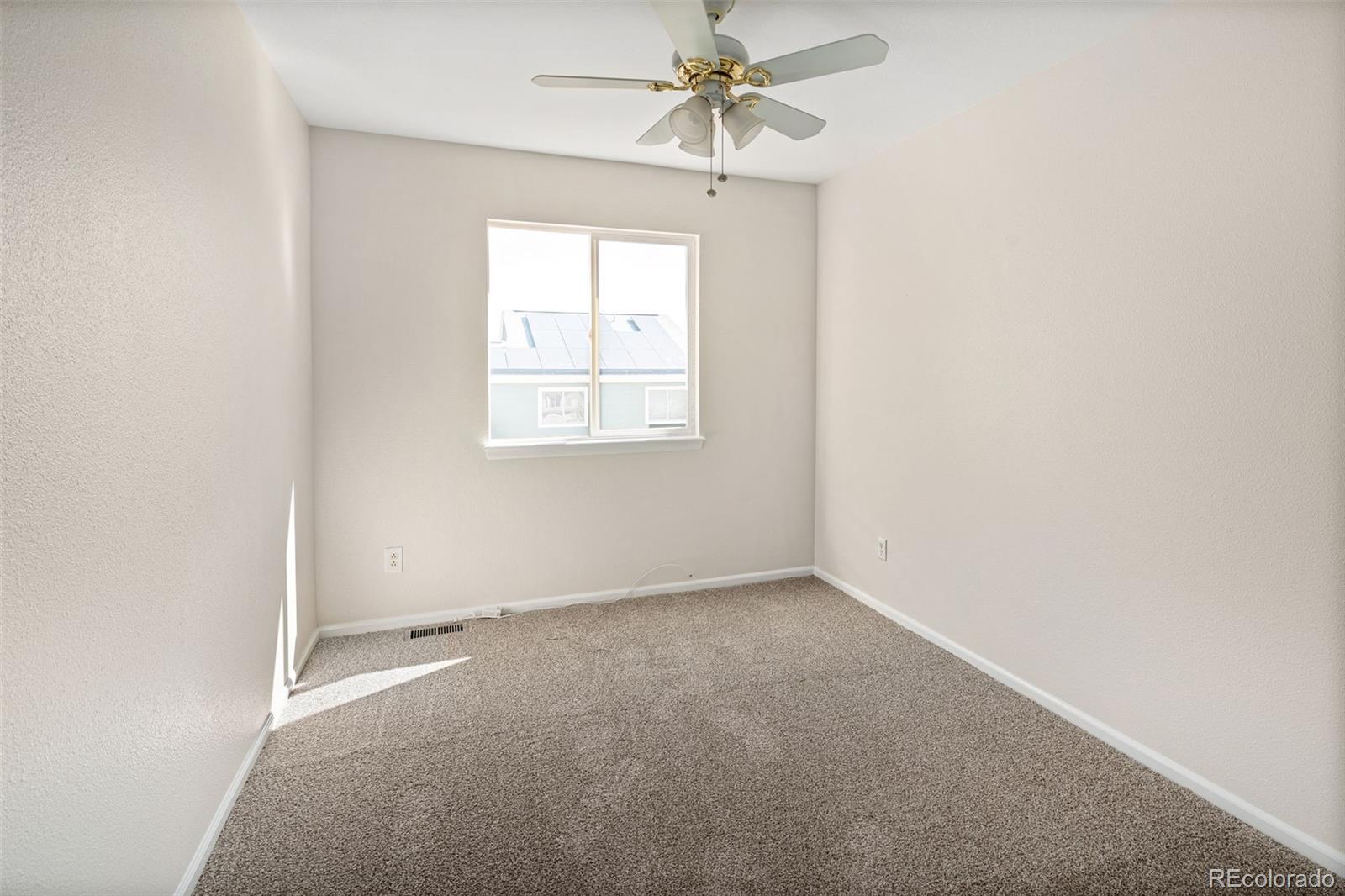9741 Moss Rose Circle Highlands Ranch, CO 80129 - Photo 33 of 46 an empty room with a window and a fan