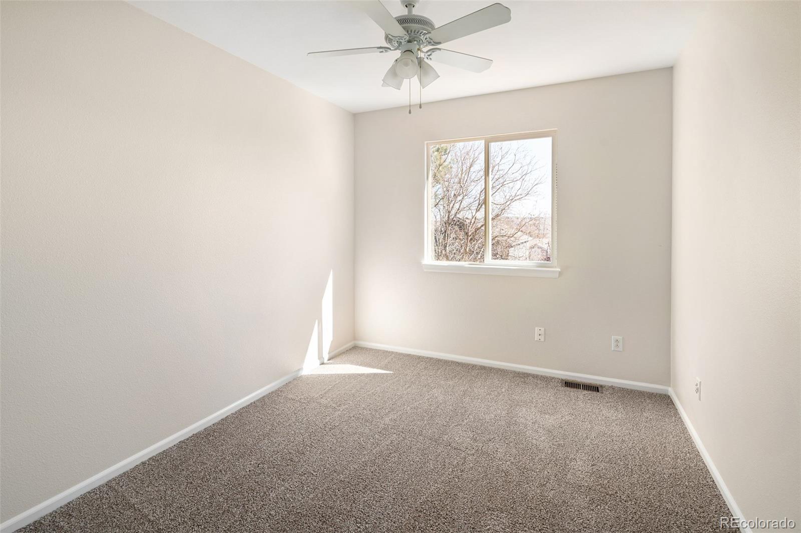 9741 Moss Rose Circle Highlands Ranch, CO 80129 - Photo 36 of 46 an empty room with windows and closet