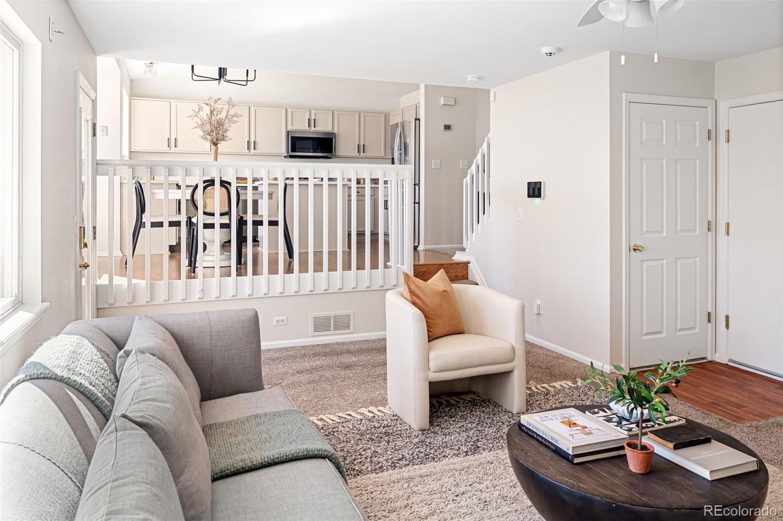 9741 Moss Rose Circle Highlands Ranch, CO 80129 - Photo 4 of 46 a living room with furniture and a table