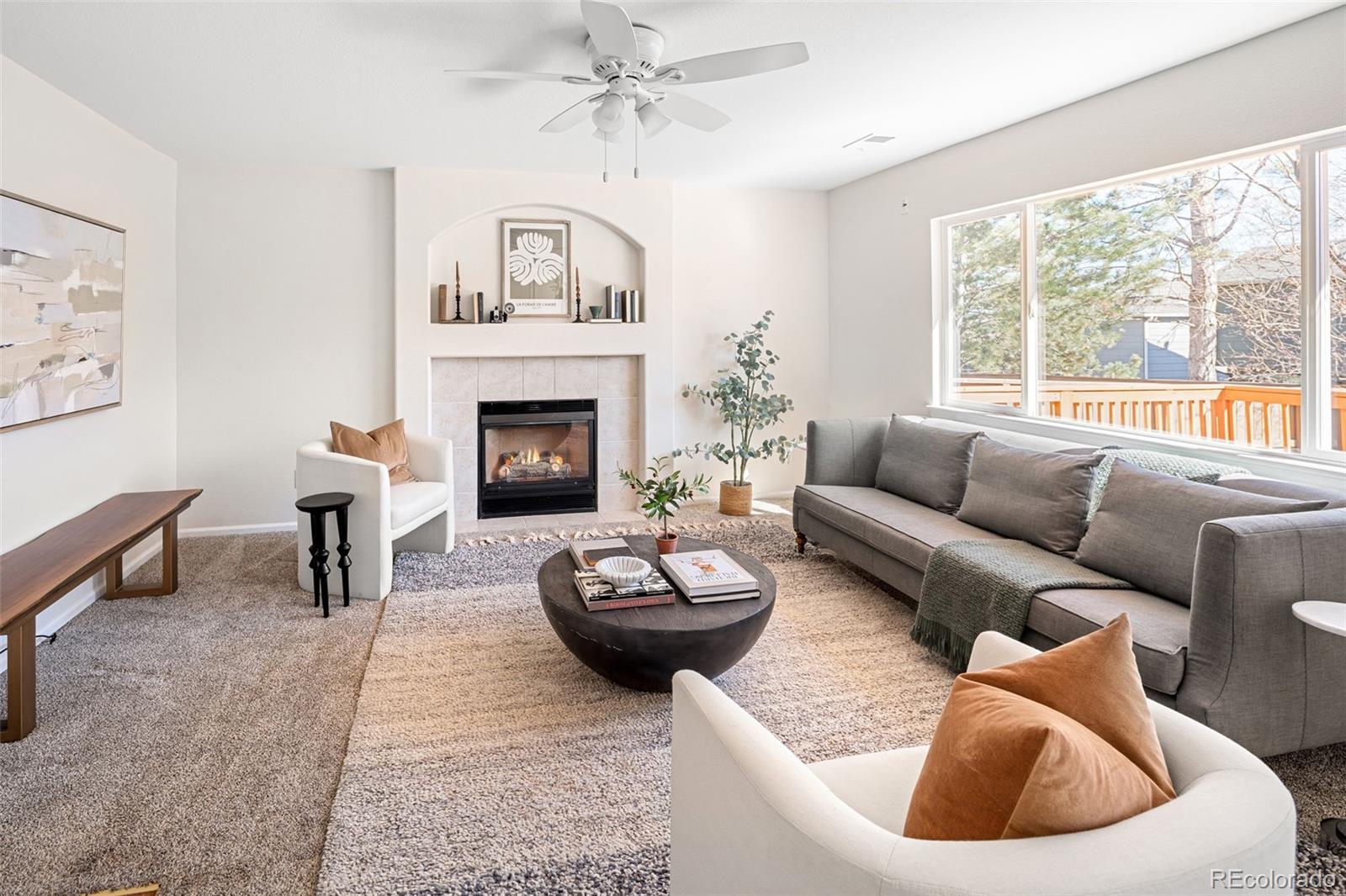 9741 Moss Rose Circle Highlands Ranch, CO 80129 - Photo 5 of 46 a living room with furniture and a fireplace