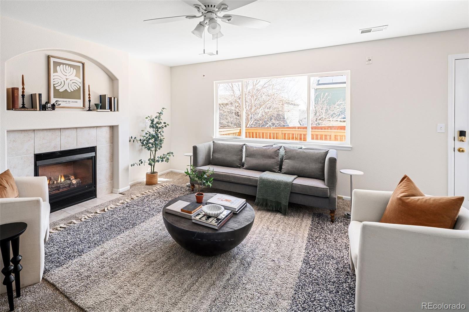 9741 Moss Rose Circle Highlands Ranch, CO 80129 - Photo 9 of 46 a living room with furniture and a fireplace