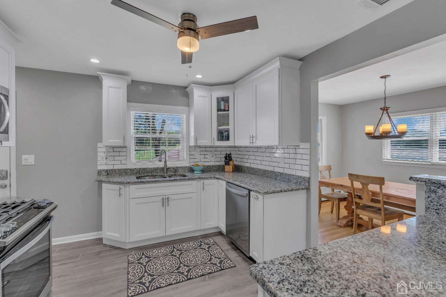 247 Davidson's Mill Road Monroe Township, NJ 08831 - Photo 12 of 55 a kitchen with stainless steel appliances granite countertop a stove a sink and a refrigerator