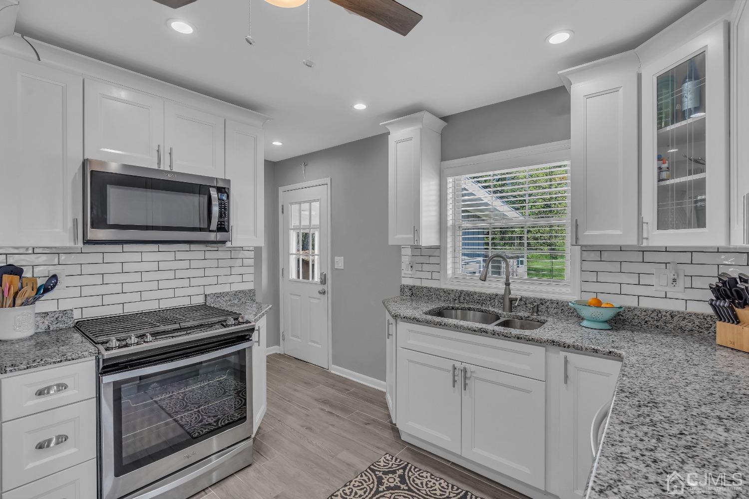 247 Davidson's Mill Road Monroe Township, NJ 08831 - Photo 17 of 55 a kitchen that has a sink and a stove