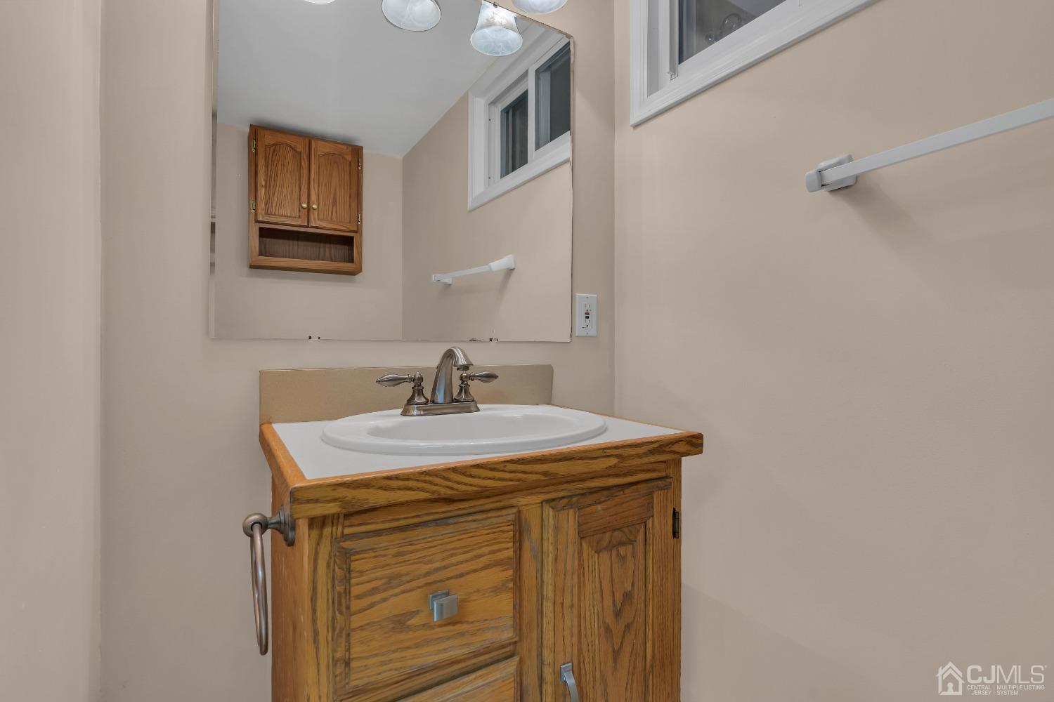 247 Davidson's Mill Road Monroe Township, NJ 08831 - Photo 29 of 55 a bathroom with a sink a vanity and mirror