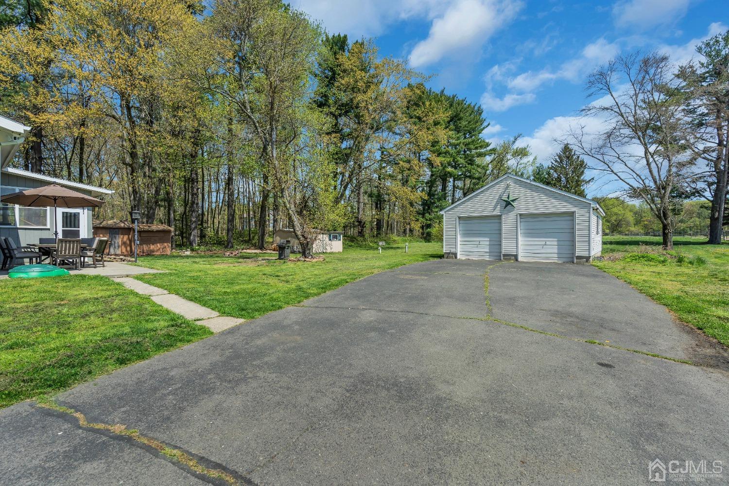 247 Davidson's Mill Road Monroe Township, NJ 08831 - Photo 35 of 55 a front view of a house with a yard and trees