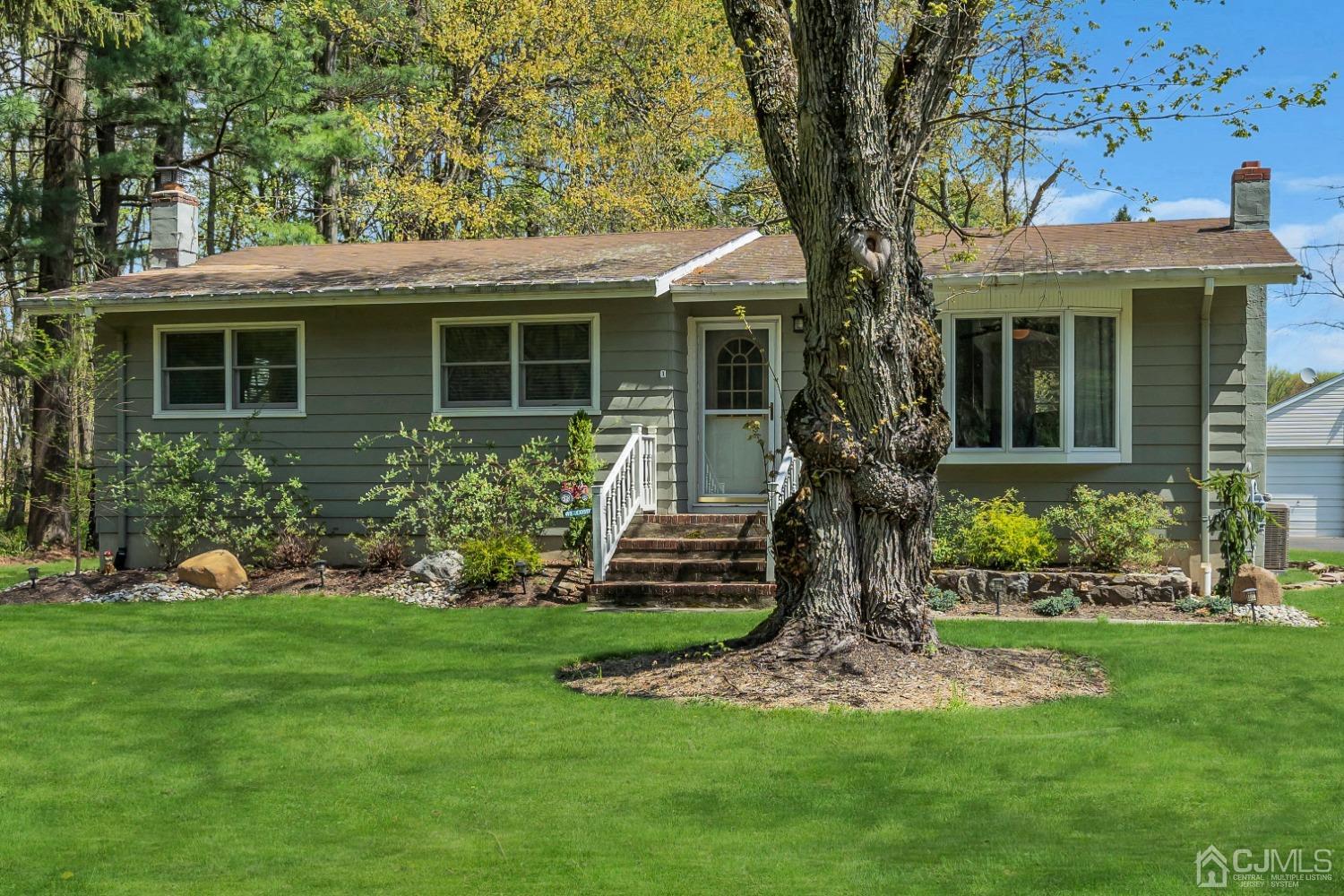 247 Davidson's Mill Road Monroe Township, NJ 08831 - Photo 4 of 55 a front view of a house with a garden and plants