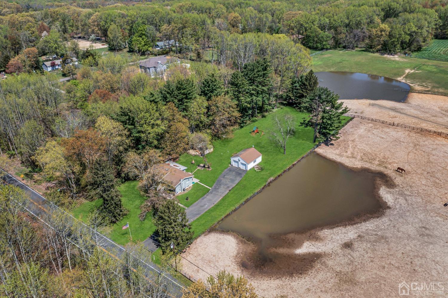 247 Davidson's Mill Road Monroe Township, NJ 08831 - Photo 42 of 55 a view of a lake with a yard and large trees