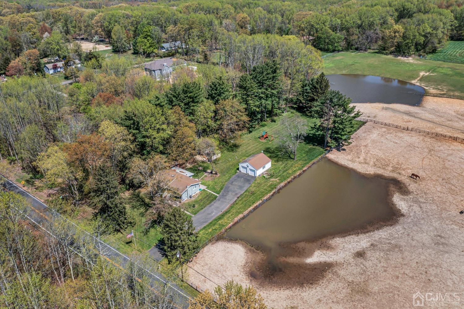 247 Davidson's Mill Road Monroe Township, NJ 08831 - Photo 50 of 55 a view of a lake with a yard and large trees