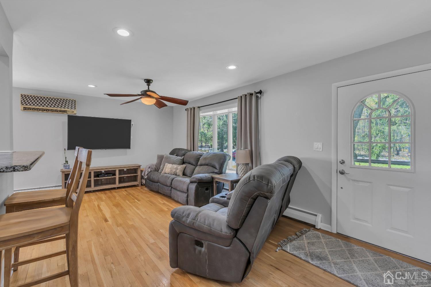 247 Davidson's Mill Road Monroe Township, NJ 08831 - Photo 7 of 55 a living room with furniture and a flat screen tv