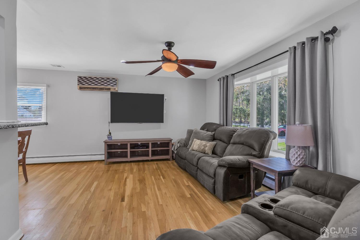 247 Davidson's Mill Road Monroe Township, NJ 08831 - Photo 8 of 55 a living room with furniture and a flat screen tv