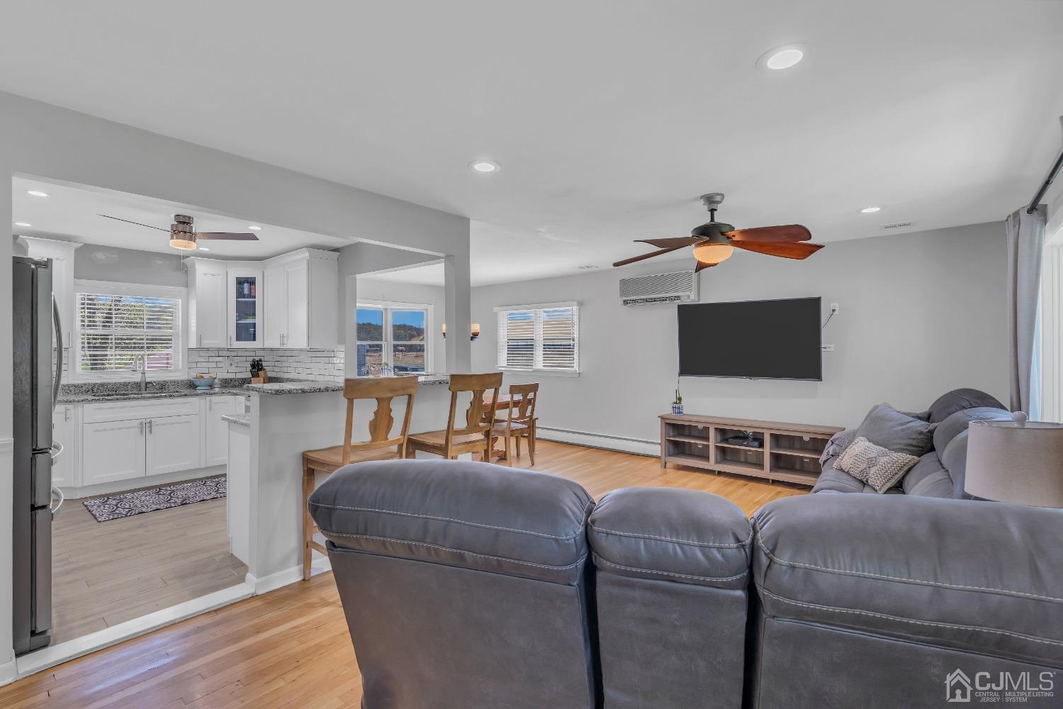 247 Davidson's Mill Road Monroe Township, NJ 08831 - Photo 10 of 55 a living room with furniture and a flat screen tv