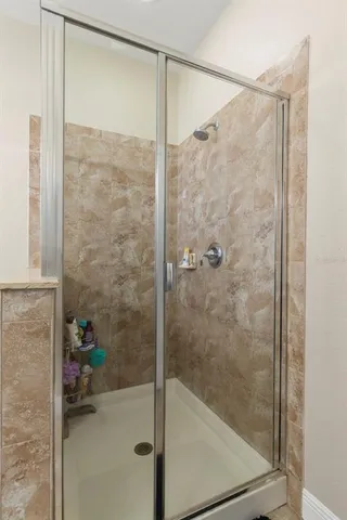 a bathroom with a glass shower door