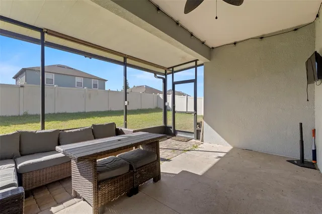 a reading room with furniture and a floor to ceiling window