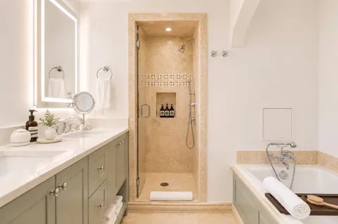 a bathroom with a tub sink and mirror