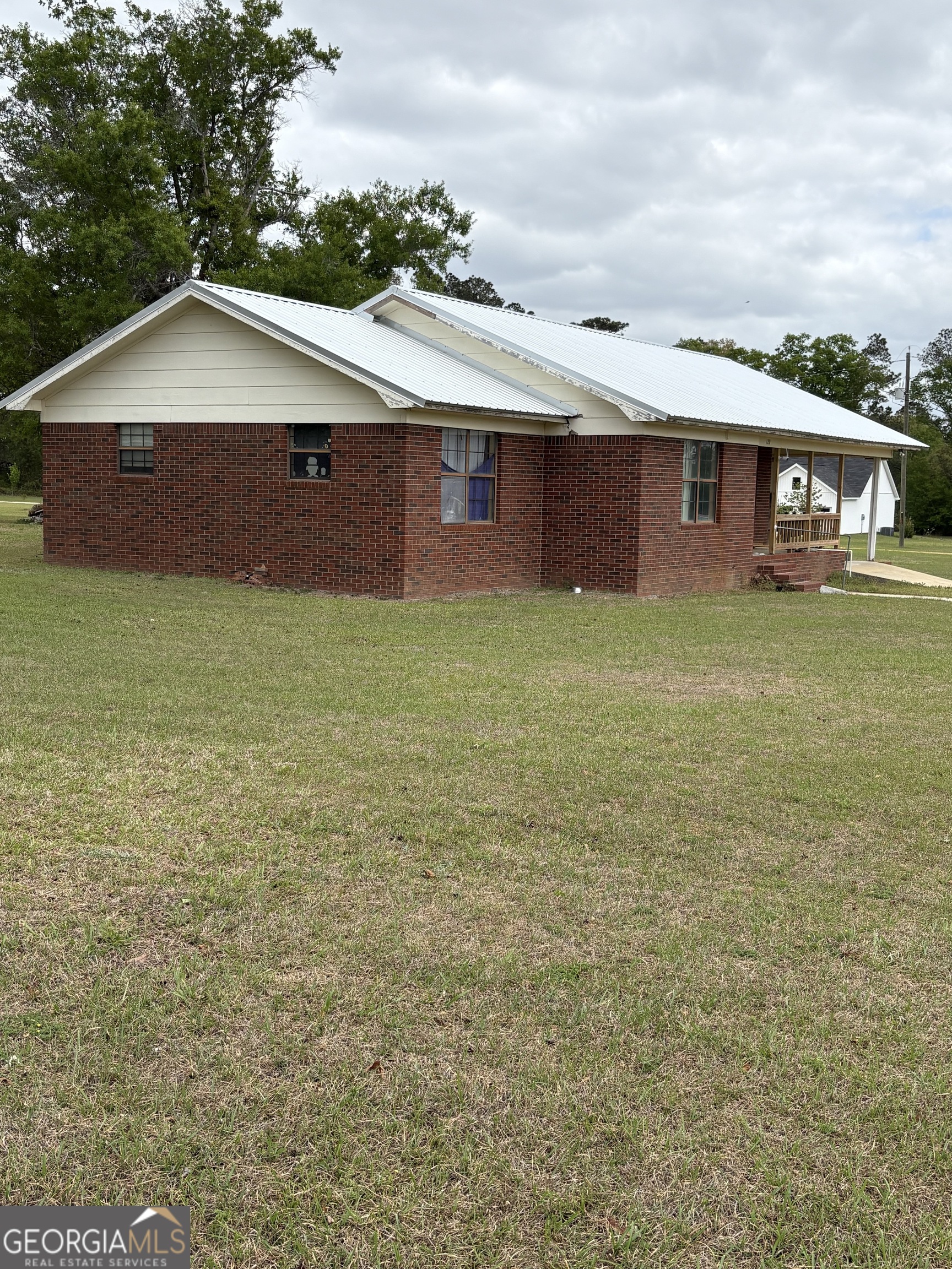 129 Cherry Street Alston, GA 30473 - Photo 2 of 4 a front view of a house with garden