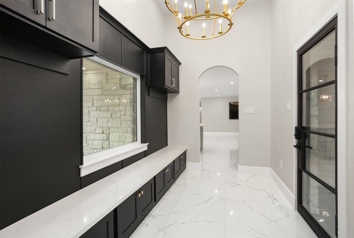 4002 Dixie Farm Road Pearland, TX 77581 - Photo 11 of 29 a view of a hallway with windows and chandelier