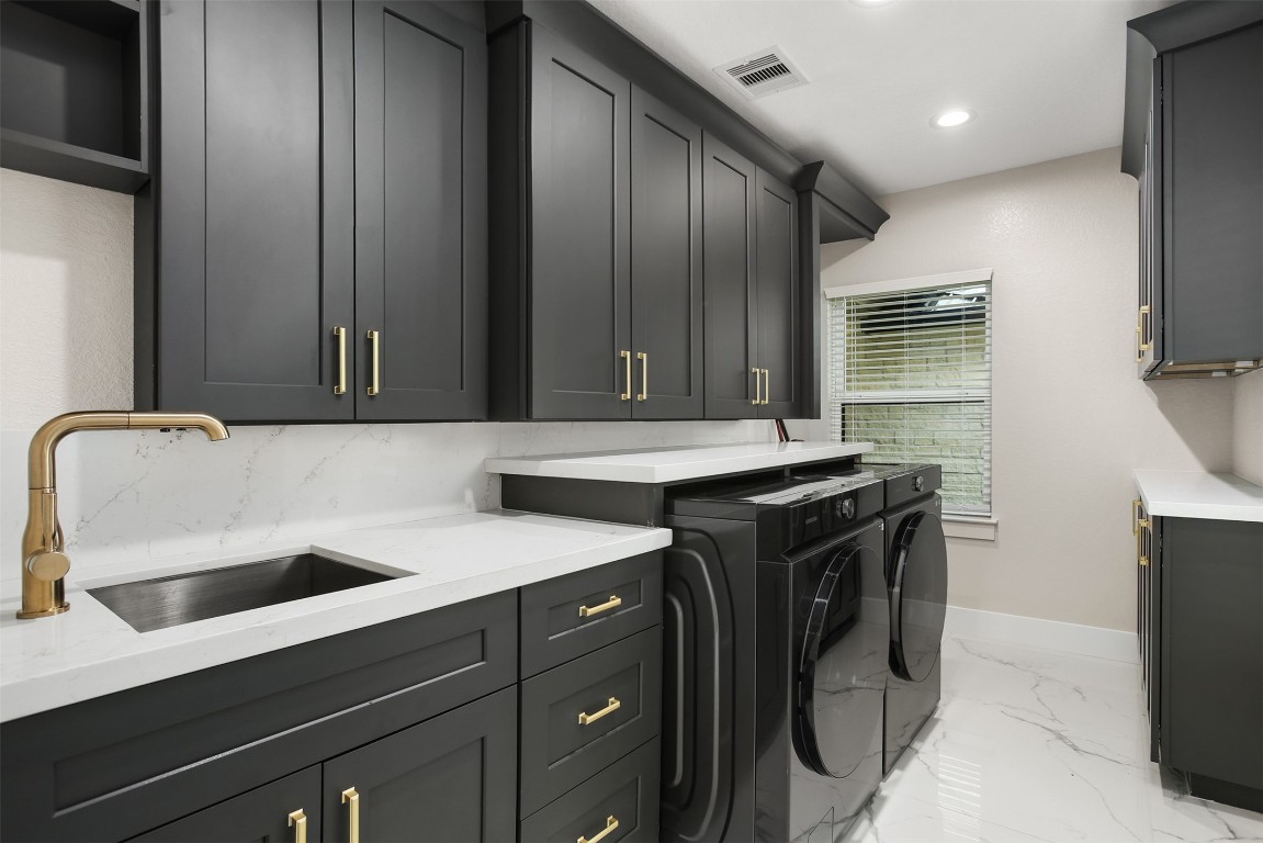 4002 Dixie Farm Road Pearland, TX 77581 - Photo 16 of 29 a utility room with a sink a washer and dryer