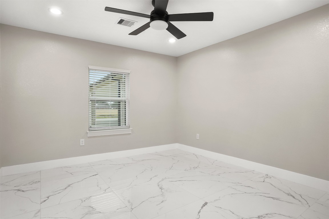 4002 Dixie Farm Road Pearland, TX 77581 - Photo 17 of 29 an empty room with windows and fan