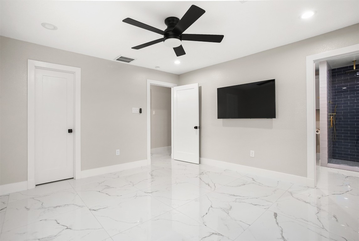 4002 Dixie Farm Road Pearland, TX 77581 - Photo 22 of 29 a view of an empty room with window and a flat screen tv