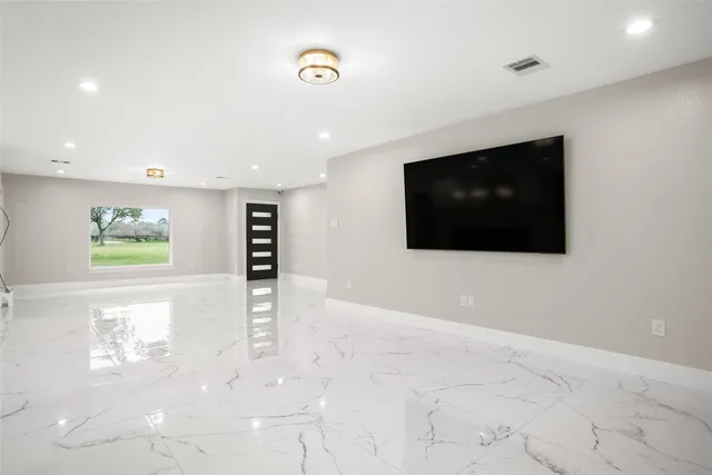 a kitchen with kitchen island granite countertop a sink a counter space appliances and cabinets