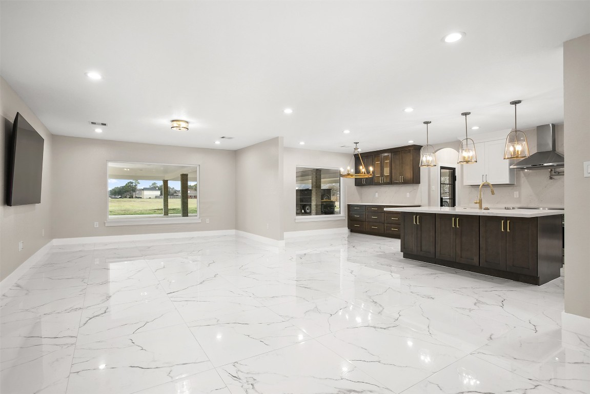 4002 Dixie Farm Road Pearland, TX 77581 - Photo 6 of 29 a view of kitchen with stainless steel appliances kitchen island granite countertop a sink and cabinets