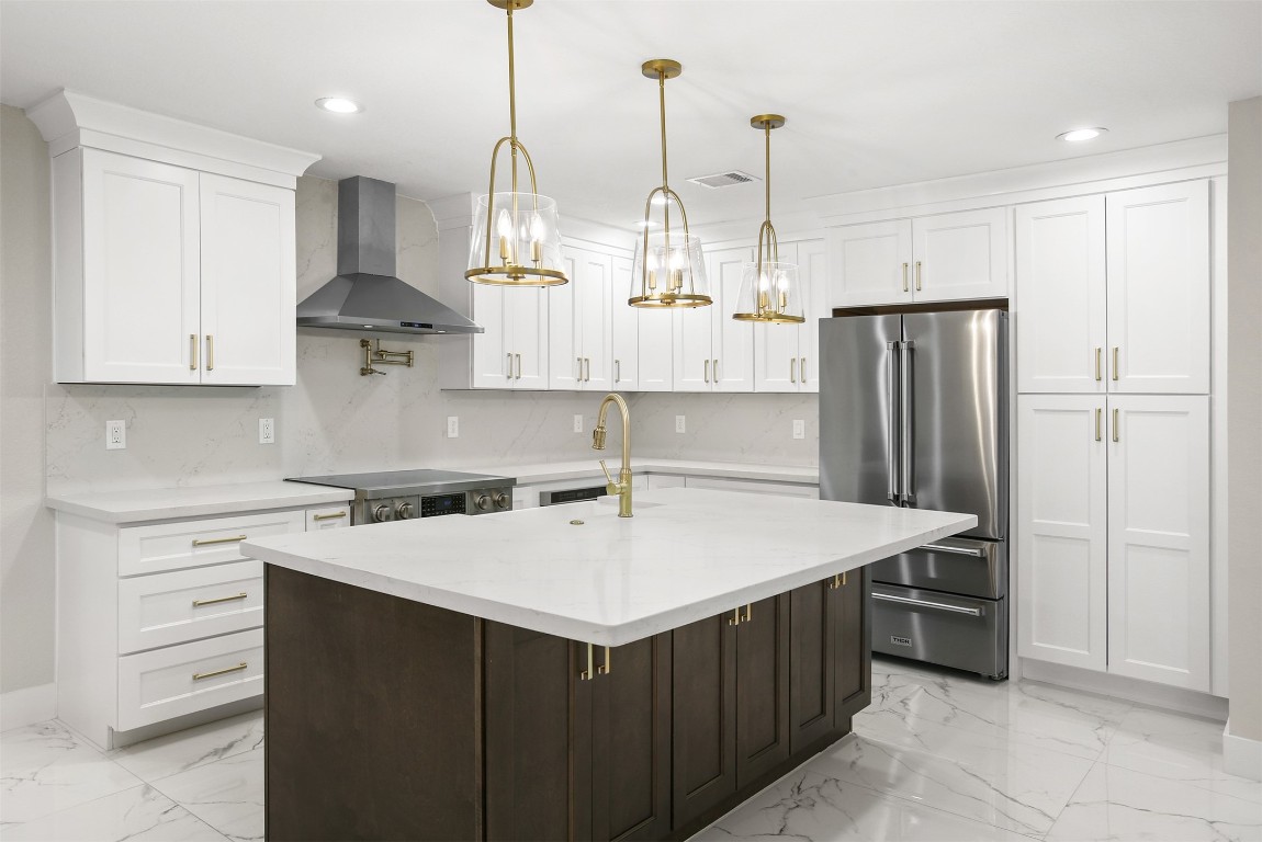 4002 Dixie Farm Road Pearland, TX 77581 - Photo 7 of 29 a kitchen with a sink a stove a refrigerator and cabinets