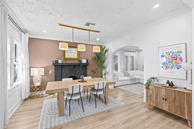 a view of a a dining room with furniture window and wooden floor