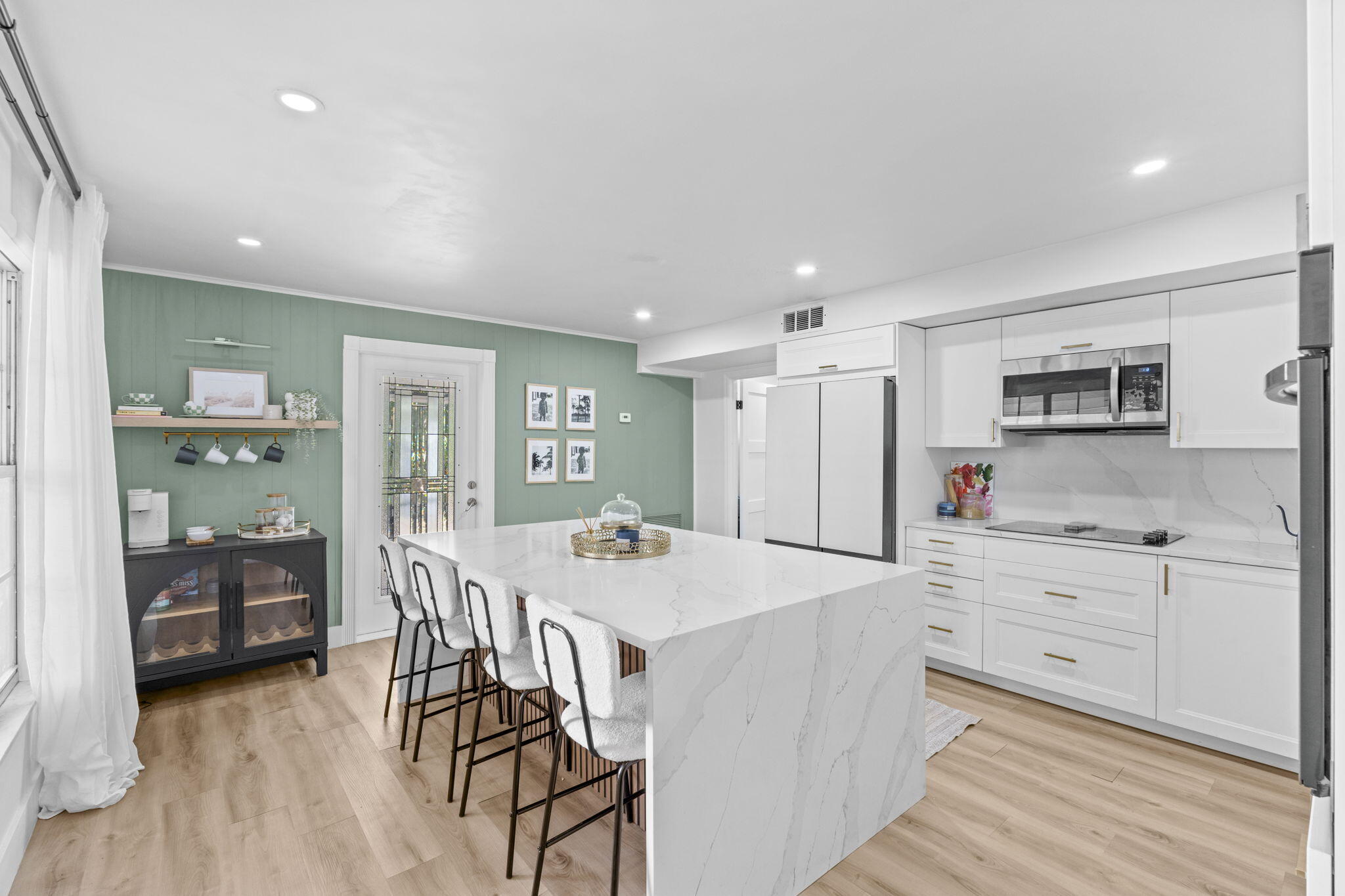 715 Kaye Street West Palm Beach, FL 33405 - Photo 17 of 40 a kitchen with a table chairs refrigerator and cabinets